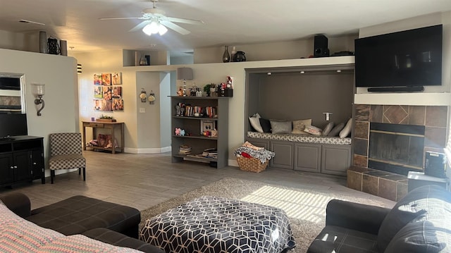2434 Cherrywood Ct, Hanford, CA 93230 - living room with ceiling fan, a tiled fireplace, and light wood-style flooring
