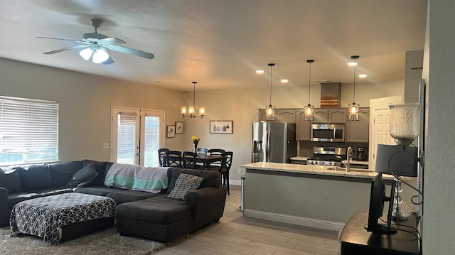 2434 Cherrywood Ct, Hanford, CA 93230 - living room featuring light wood-style floors, a chandelier, and ceiling fan