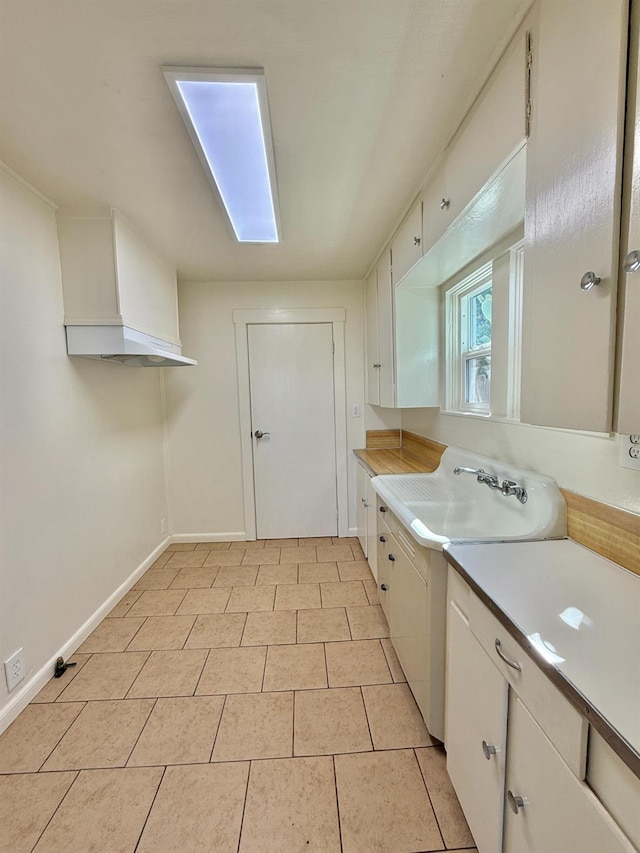 2824 C St, Selma, CA 93662 - kitchen featuring light countertops, white cabinetry, and light tile patterned flooring