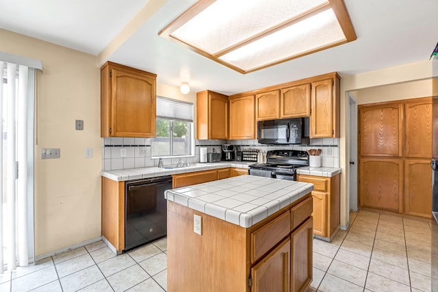2687 Fowler Ave, Clovis, CA 93611 - kitchen featuring black appliances, tile counters, backsplash, and light tile patterned flooring