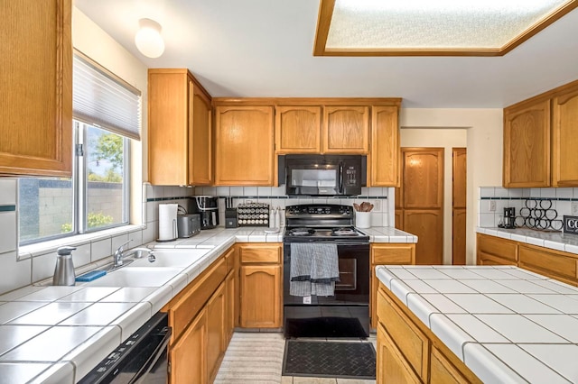2687 Fowler Ave, Clovis, CA 93611 - kitchen featuring black appliances, tile countertops, and tasteful backsplash