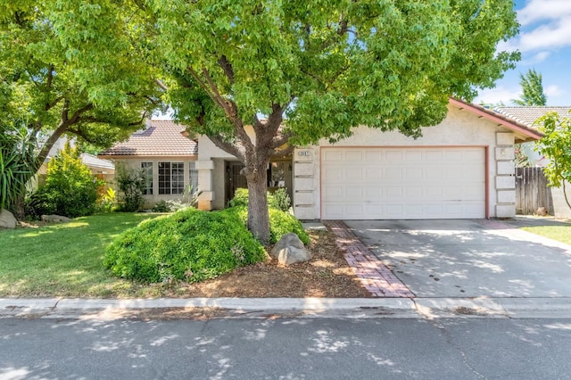 2687 Fowler Ave, Clovis, CA 93611 - view of property hidden behind natural elements with a tiled roof, driveway, and stucco siding