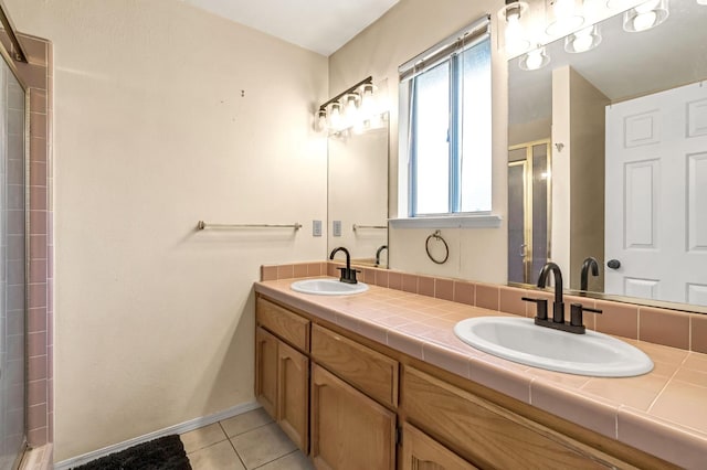 2687 Fowler Ave, Clovis, CA 93611 - full bath with tile patterned flooring, double vanity, and a shower with door