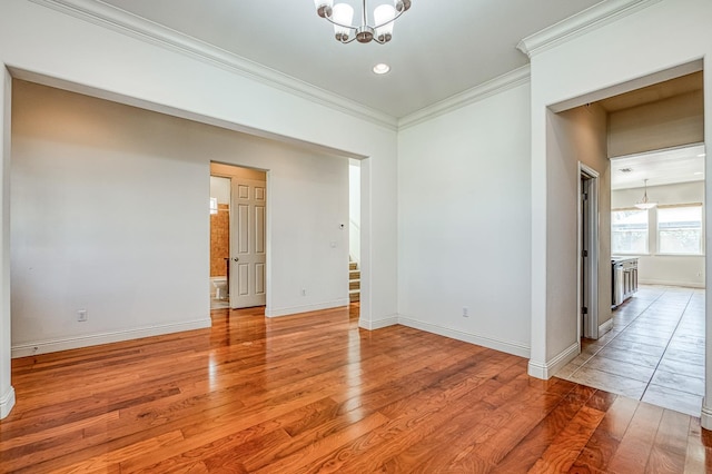 2593 E Utah, Fresno, CA 93720 - spare room featuring a chandelier, light wood-style floors, ornamental molding, stairway, and recessed lighting