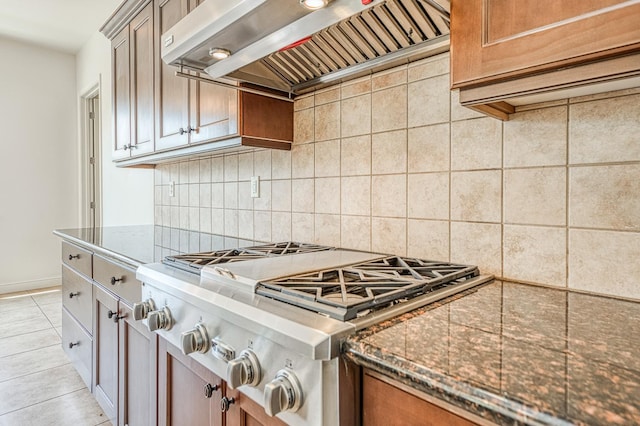 2593 E Utah, Fresno, CA 93720 - kitchen featuring wall chimney range hood, stainless steel gas cooktop, decorative backsplash, and dark stone countertops