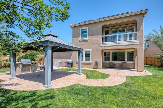 2593 E Utah, Fresno, CA 93720 - back of house featuring a balcony, stucco siding, area for grilling, a patio area, and a gazebo