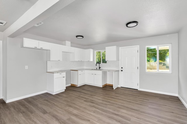 1934 W Pontiac Way, Fresno, CA 93705 - kitchen with tasteful backsplash, wood finished floors, white cabinets, a textured ceiling, and light countertops