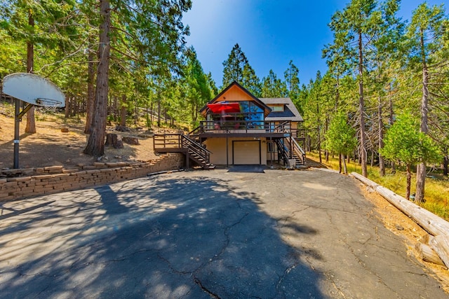 53608 Chipo Poyah, North Fork, CA 93643 - view of front of house with stairs, driveway, a deck, and a garage