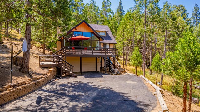 53608 Chipo Poyah, North Fork, CA 93643 - chalet / cabin with stairway, asphalt driveway, a deck, and an attached garage
