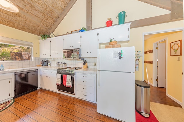53608 Chipo Poyah, North Fork, CA 93643 - kitchen with appliances with stainless steel finishes, tile counters, lofted ceiling, white cabinets, and wood finished floors