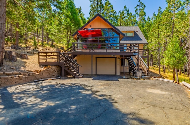 53608 Chipo Poyah, North Fork, CA 93643 - view of front of home featuring stairs, driveway, an attached garage, a wooden deck, and roof with shingles