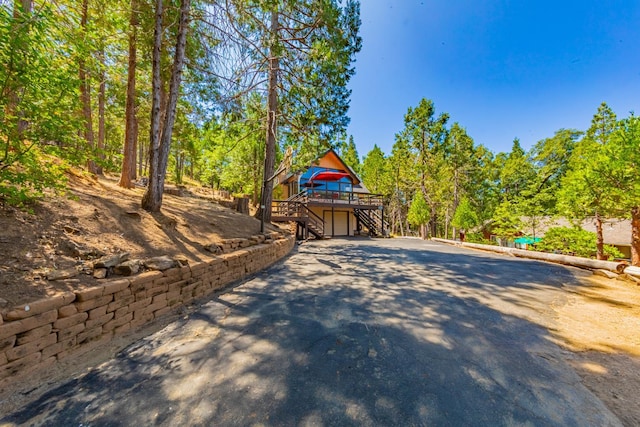 53608 Chipo Poyah, North Fork, CA 93643 - view of patio / terrace featuring stairway, a garage, a wooden deck, and driveway