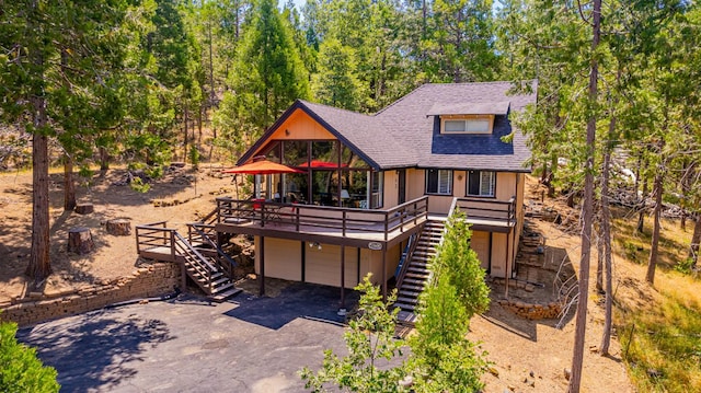 53608 Chipo Poyah, North Fork, CA 93643 - view of front facade featuring stairway, a wooden deck, driveway, and roof with shingles