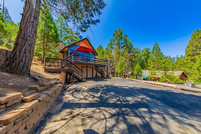 53608 Chipo Poyah, North Fork, CA 93643 - view of yard with stairway, asphalt driveway, a wooden deck, and a garage