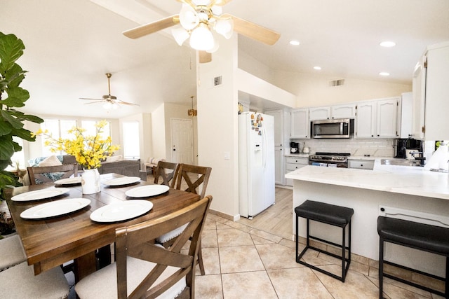 5263 W Griffith Way, Fresno, CA 93722 - dining room featuring lofted ceiling, a ceiling fan, light tile patterned flooring, and recessed lighting