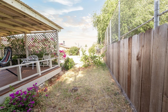 5263 W Griffith Way, Fresno, CA 93722 - view of yard featuring a deck