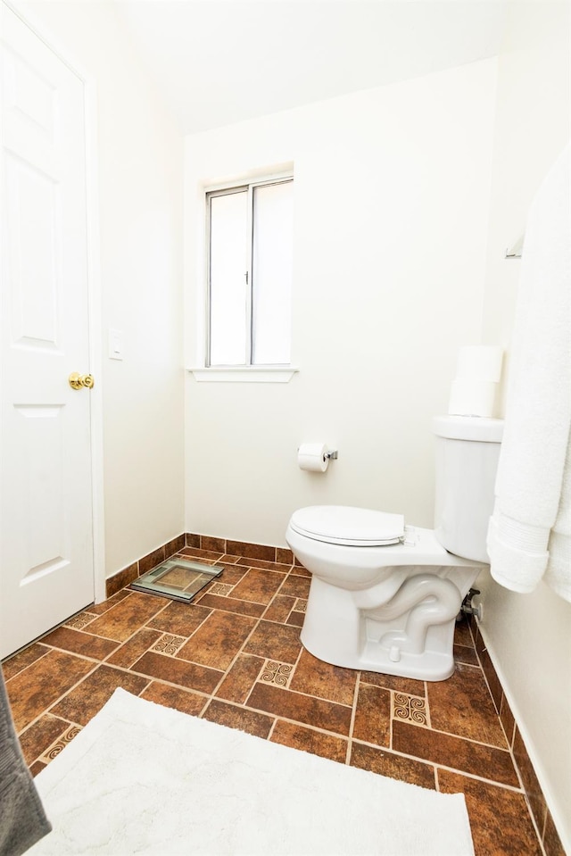 5263 W Griffith Way, Fresno, CA 93722 - bathroom with toilet and stone finish flooring