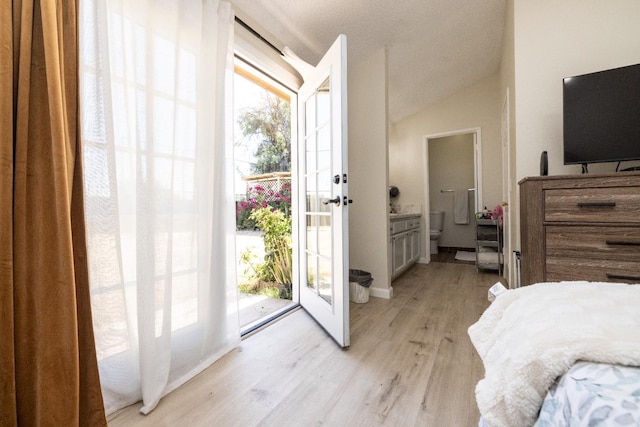 5263 W Griffith Way, Fresno, CA 93722 - bedroom with multiple windows, light wood-type flooring, access to exterior, french doors, and vaulted ceiling