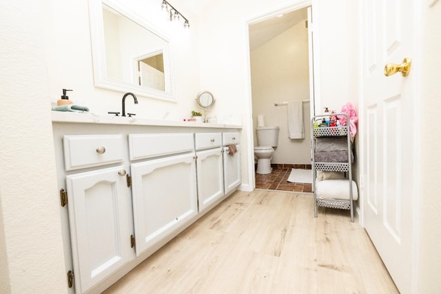 5263 W Griffith Way, Fresno, CA 93722 - bathroom featuring vanity and wood finished floors
