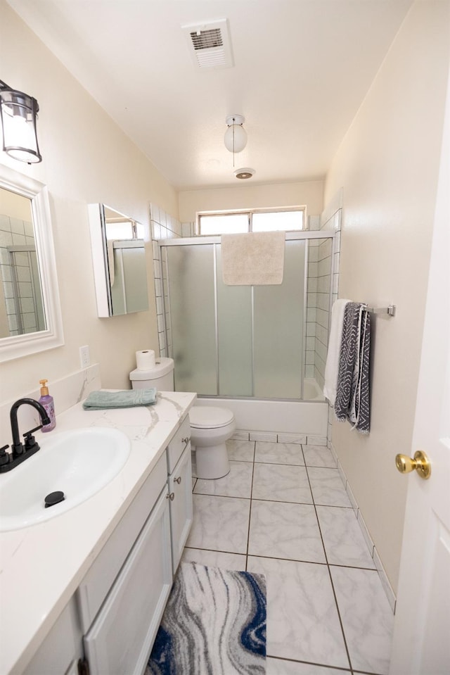 5263 W Griffith Way, Fresno, CA 93722 - full bathroom featuring marble look tiles, shower / bath combination with glass door, and vanity