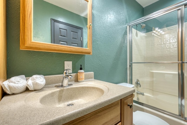 42055 Saddleback Rd, Shaver Lake, CA 93664 - full bathroom with a textured wall, vanity, and combined bath / shower with glass door