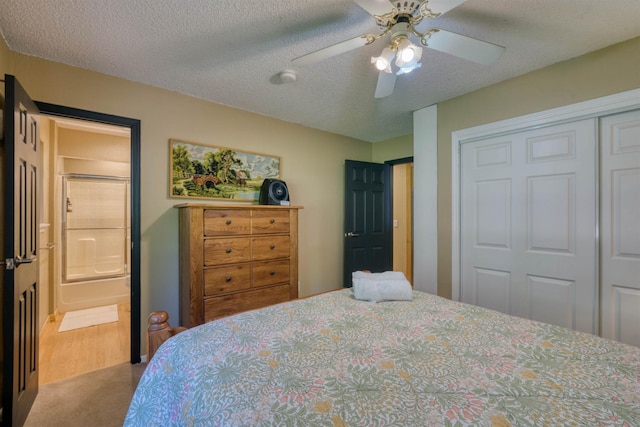 42055 Saddleback Rd, Shaver Lake, CA 93664 - bedroom featuring a closet, carpet floors, ceiling fan, ensuite bath, and a textured ceiling