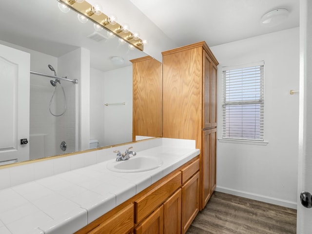 180 N Anderson Ave, Clovis, CA 93612 - bathroom with vanity, wood finished floors, and washtub / shower combination