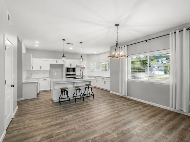 180 N Anderson Ave, Clovis, CA 93612 - kitchen with stainless steel appliances, recessed lighting, light countertops, backsplash, and white cabinets