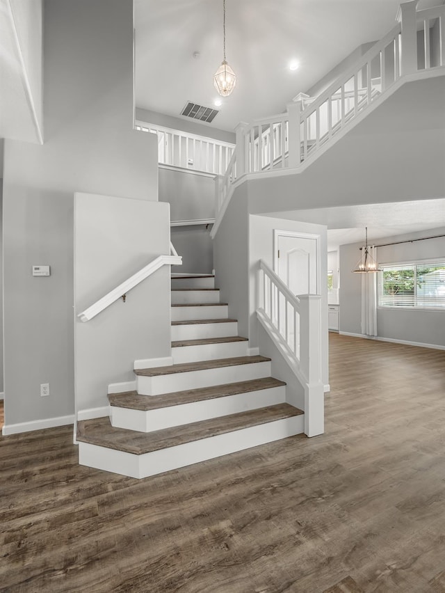 180 N Anderson Ave, Clovis, CA 93612 - stairway with a chandelier, a towering ceiling, wood finished floors, and recessed lighting