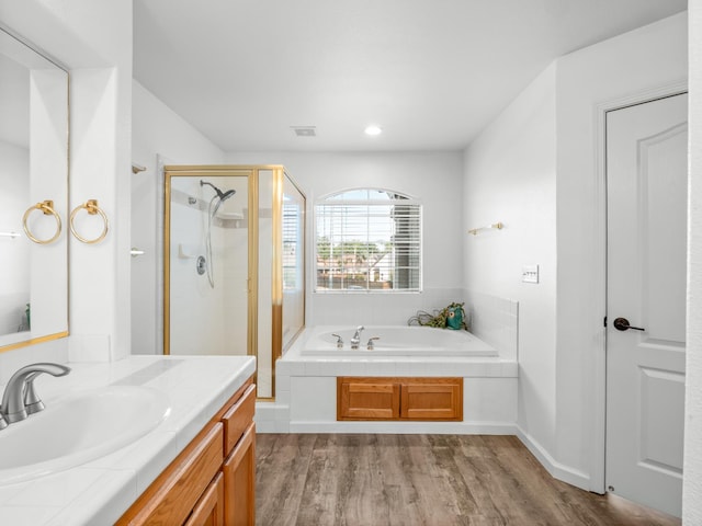 180 N Anderson Ave, Clovis, CA 93612 - bathroom with a shower stall, a bath, vanity, wood finished floors, and recessed lighting