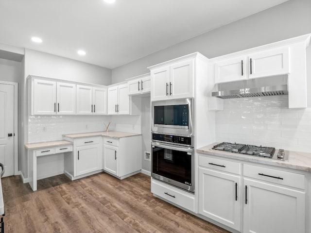 180 N Anderson Ave, Clovis, CA 93612 - kitchen featuring stainless steel appliances, exhaust hood, white cabinets, backsplash, and recessed lighting
