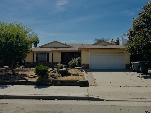 3043 N Brunswick Ave, Fresno, CA 93722 - ranch-style home with an attached garage, concrete driveway, and stucco siding