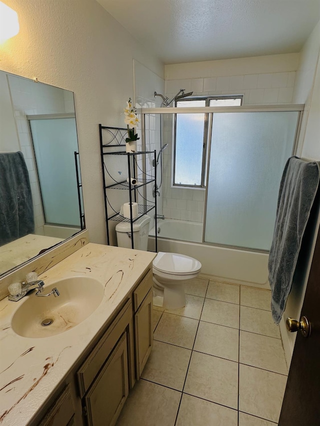3043 N Brunswick Ave, Fresno, CA 93722 - bathroom with vanity, bath / shower combo with glass door, and tile patterned flooring