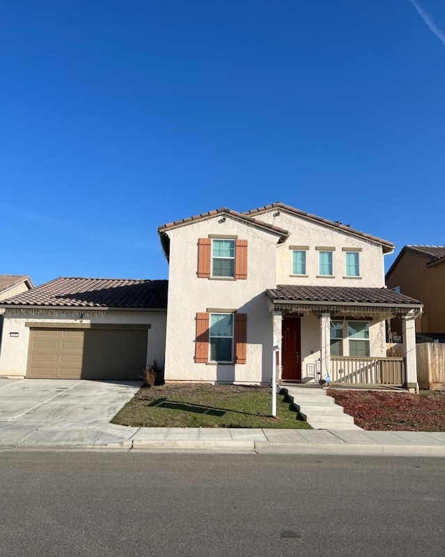 4542 N Casey Ave, Fresno, CA 93723 - view of front of property featuring a porch, a garage, stucco siding, and concrete driveway