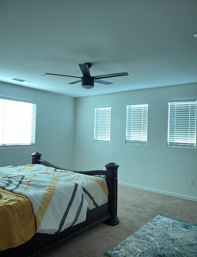 4542 N Casey Ave, Fresno, CA 93723 - carpeted bedroom with multiple windows and a ceiling fan