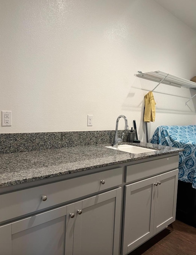 4542 N Casey Ave, Fresno, CA 93723 - kitchen with gray cabinetry, dark wood-type flooring, and dark stone countertops