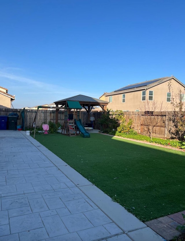 4542 N Casey Ave, Fresno, CA 93723 - fenced backyard with a playground, a patio area, and a gazebo