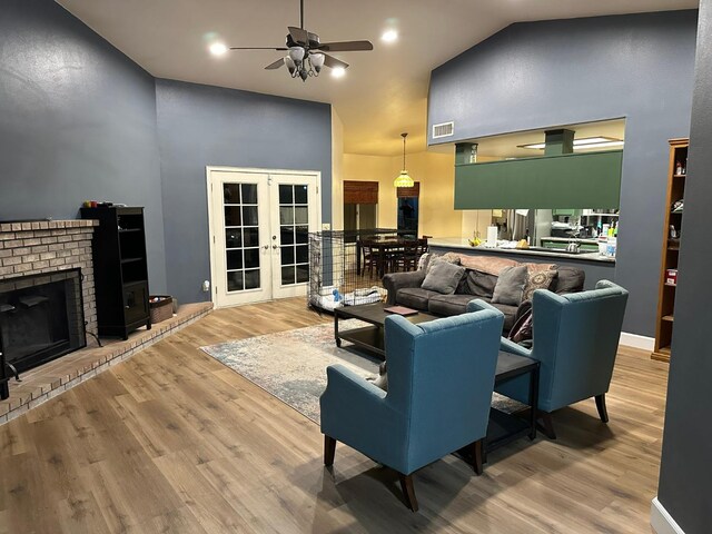 2526 Gibson Ave, Clovis, CA 93611 - living area featuring high vaulted ceiling, french doors, a ceiling fan, wood finished floors, and a fireplace