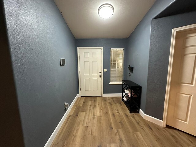 2526 Gibson Ave, Clovis, CA 93611 - doorway featuring wood finished floors and a textured wall