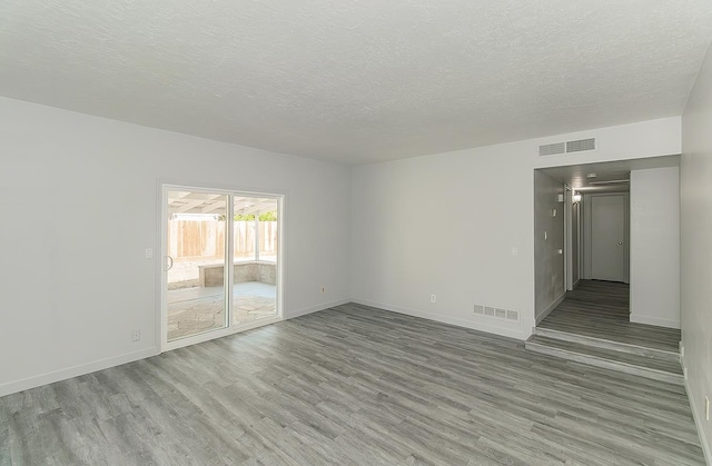 6683 N Spalding Ave, Fresno, CA 93710 - empty room with light wood-style floors and a textured ceiling