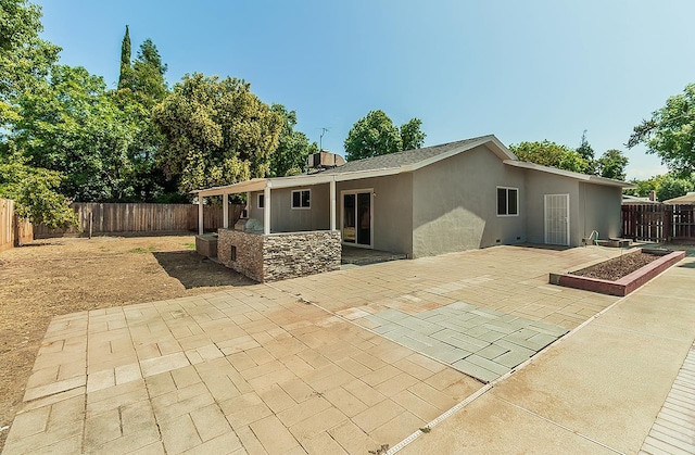 6683 N Spalding Ave, Fresno, CA 93710 - rear view of property featuring a patio, stucco siding, and a fenced backyard