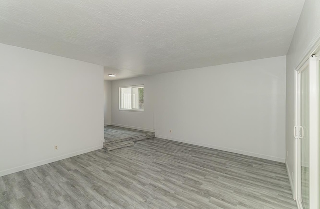 6683 N Spalding Ave, Fresno, CA 93710 - empty room featuring light wood-style flooring and a textured ceiling