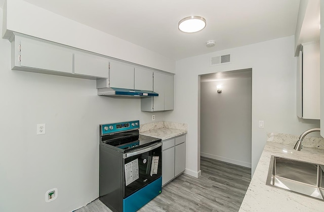 6683 N Spalding Ave, Fresno, CA 93710 - kitchen with black electric range oven, under cabinet range hood, light wood finished floors, gray cabinets, and light stone countertops