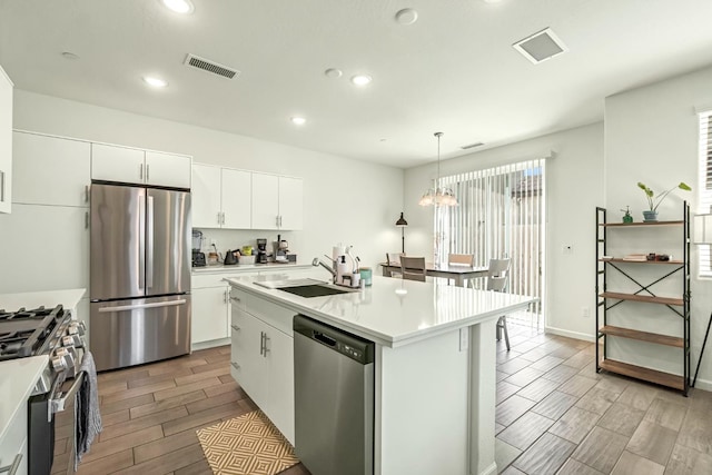2047 N Ralph Ln, Clovis, CA 93619 - kitchen featuring stainless steel appliances, wood tiled floors, recessed lighting, light countertops, and pendant lighting