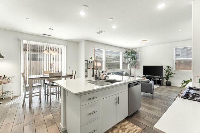 2047 N Ralph Ln, Clovis, CA 93619 - kitchen with dishwasher, light wood finished floors, recessed lighting, a chandelier, and light countertops