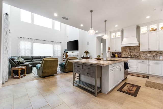 4693 Del Oro Rd, Madera, CA 93636 - kitchen featuring premium range hood, open floor plan, light stone countertops, white cabinetry, and recessed lighting