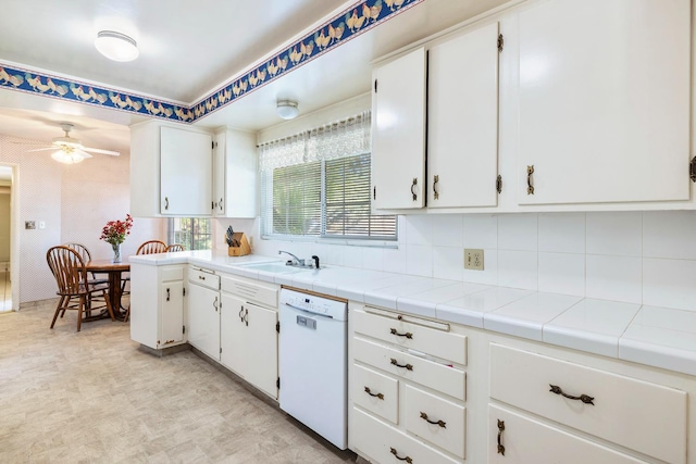 1216 E Pico Ave, Fresno, CA 93704 - kitchen with white dishwasher, white cabinetry, ceiling fan, and tasteful backsplash