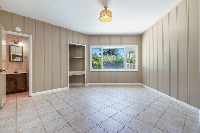 1216 E Pico Ave, Fresno, CA 93704 - unfurnished bedroom featuring light tile patterned floors and a decorative wall