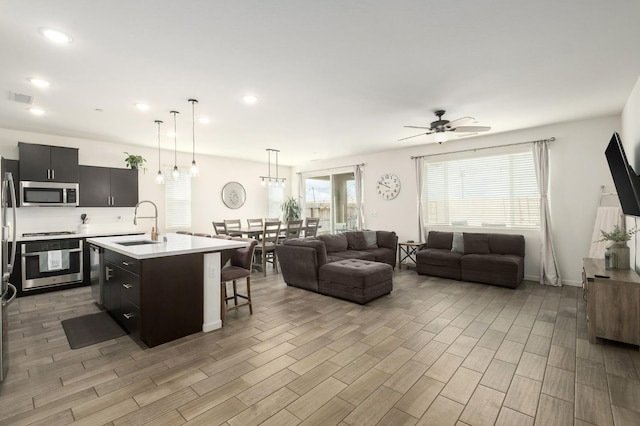 644 Atlantica Dr S, Madera, CA 93636 - living area with light wood-type flooring, a ceiling fan, and recessed lighting