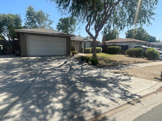 3317 W Indianapolis Ave, Fresno, CA 93722 - ranch-style house featuring driveway, a garage, and stucco siding